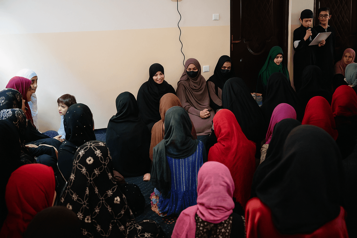 Community gathering with Afghan women and girls participating in an educational workshop